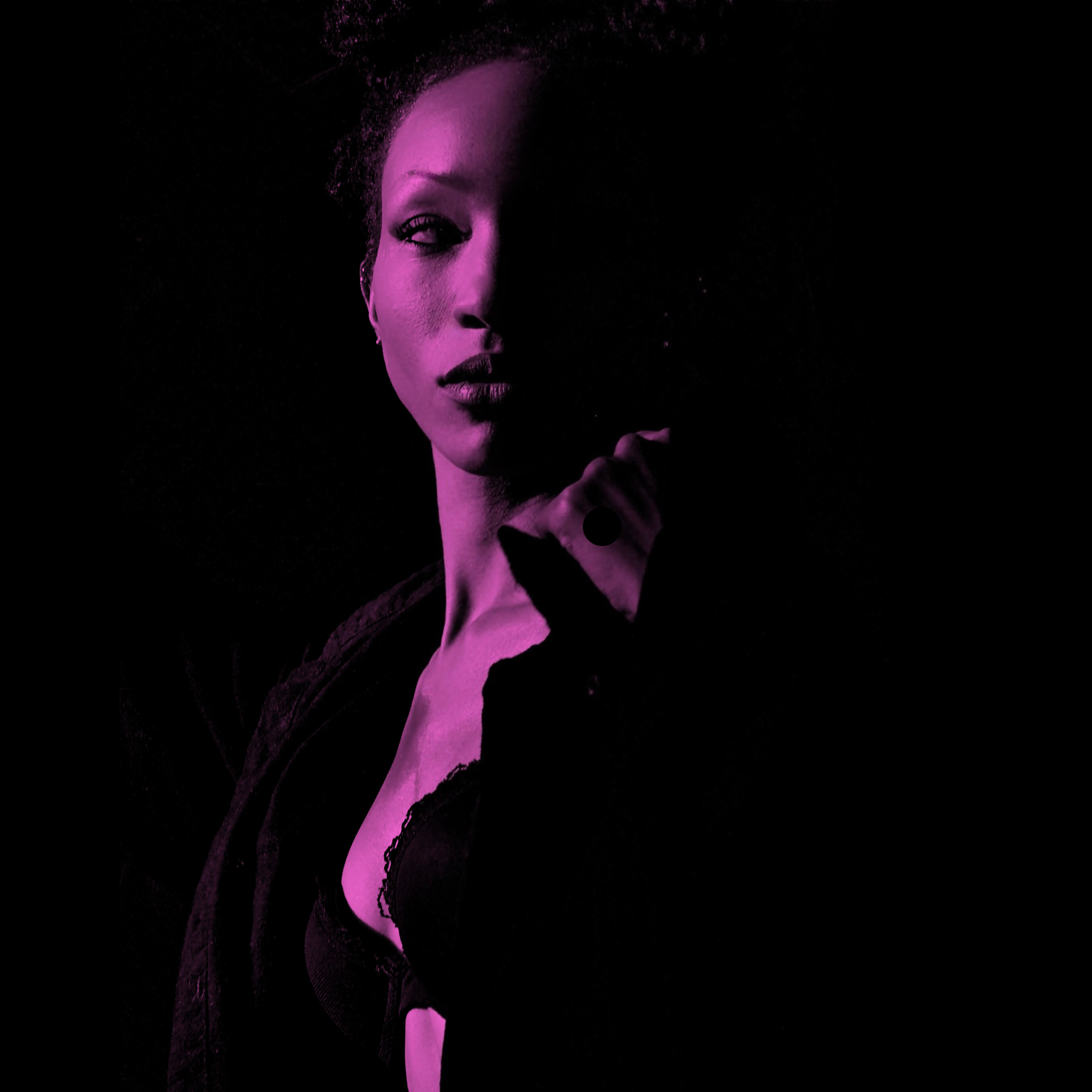 Lunah Moore half lit in deep shadow with a lavender glow