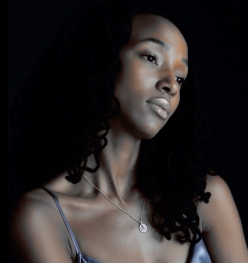 Lunah Moore in a dark atmosphere with a moonlight glow on her skin